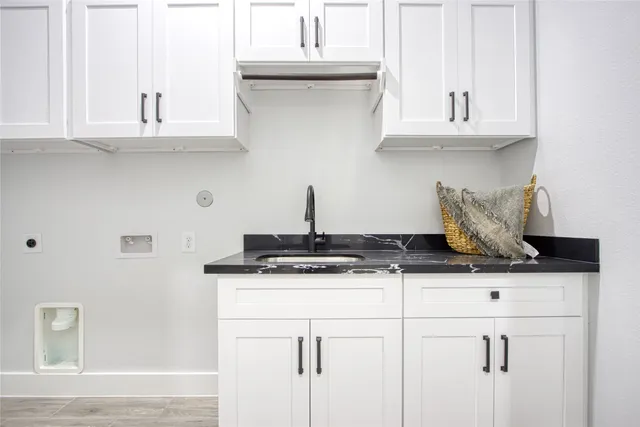 a bathroom with a granite countertop toilet sink and mirror