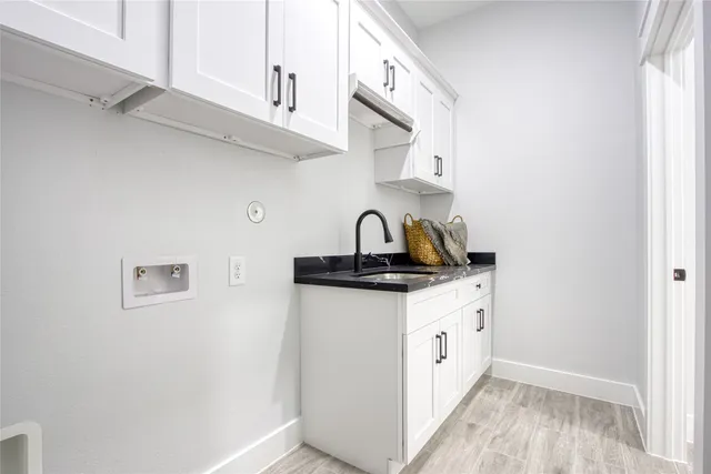 a kitchen with stainless steel appliances granite countertop a sink a stove and cabinets