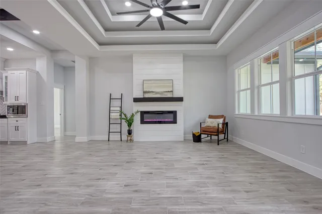 a view of a livingroom with fireplace and a ceiling fan
