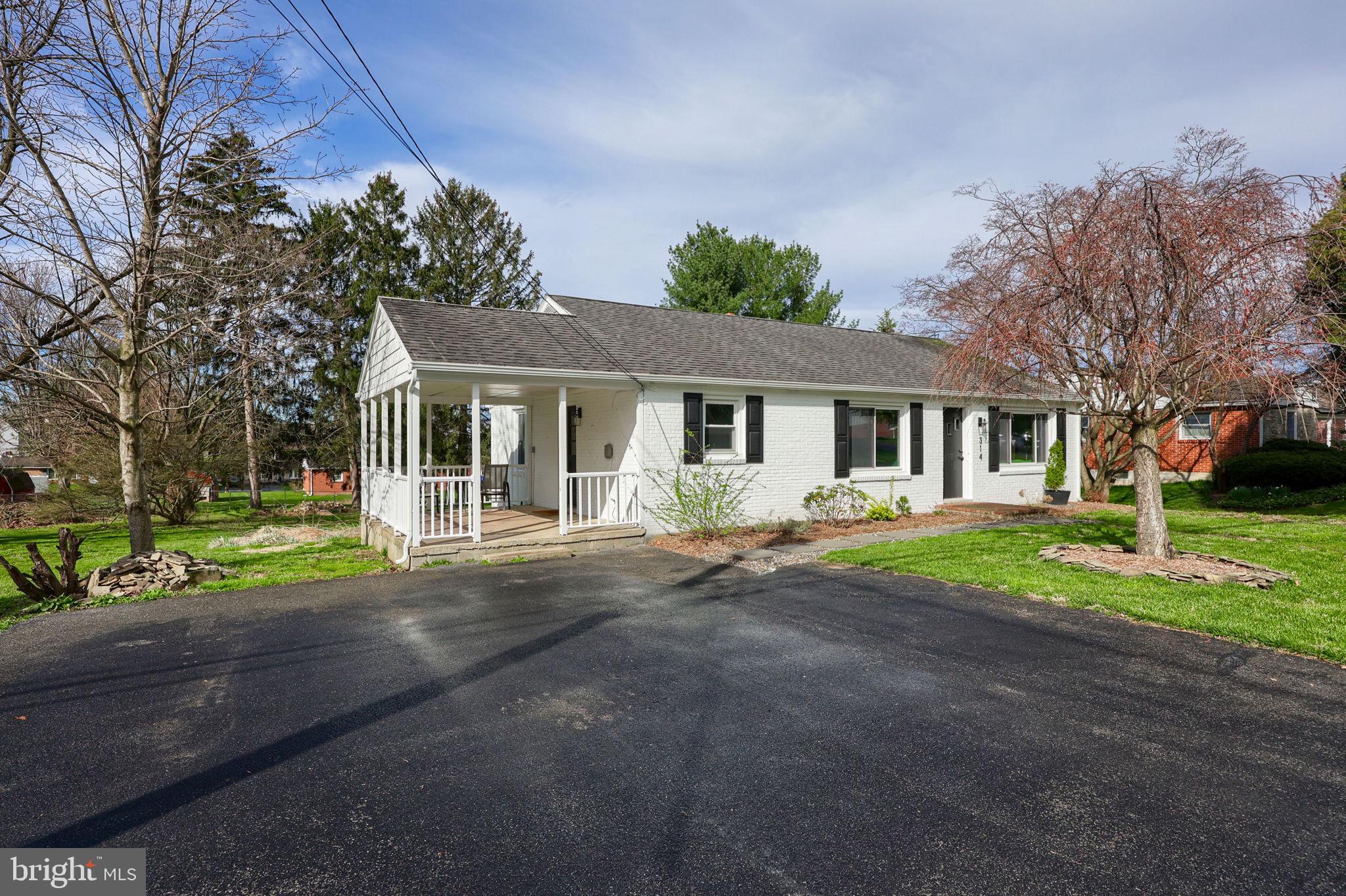 314 Dahlia Road Lancaster, PA 17602 - Photo 2 of 28 a front view of a house with a yard and porch