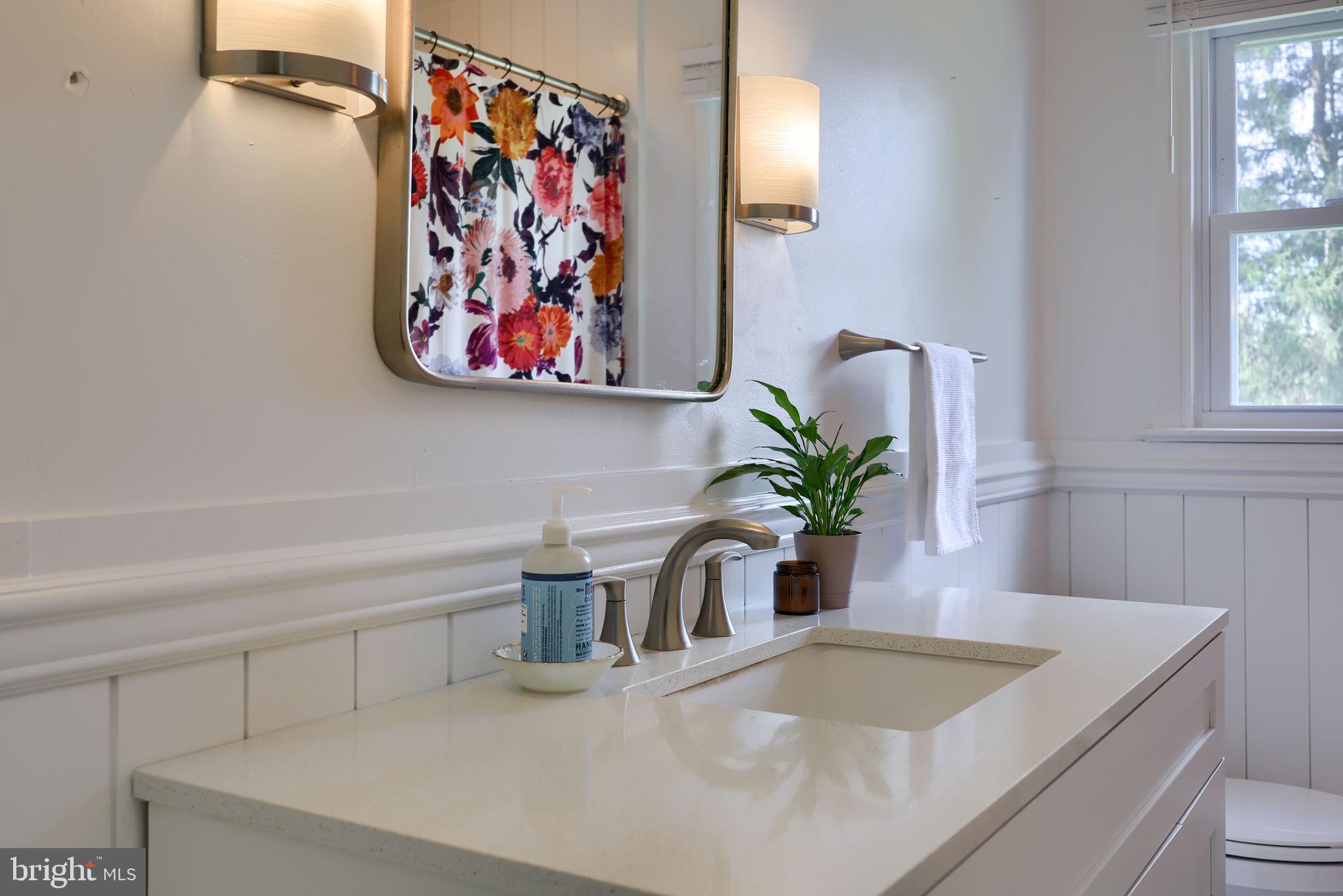 314 Dahlia Road Lancaster, PA 17602 - Photo 22 of 28 a bathroom with a granite countertop sink a vanity and a window