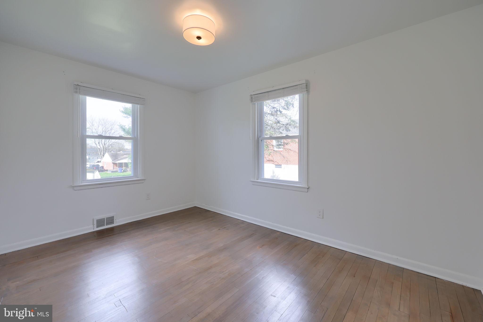 314 Dahlia Road Lancaster, PA 17602 - Photo 25 of 28 an empty room with wooden floor and windows