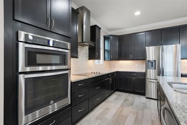 an empty room with wooden floor & windows