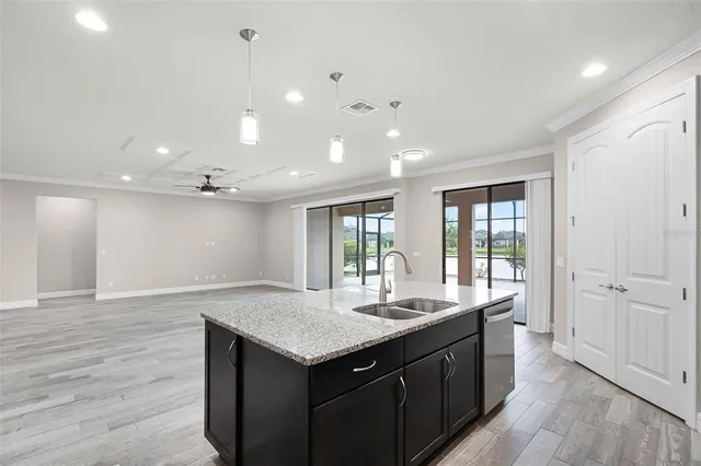 an empty room with wooden floor closet and ceiling fan
