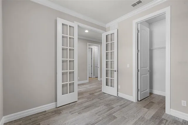 a bathroom with a granite countertop double vanity sink a mirror and a toilet