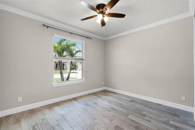 wooden floor in an empty room with a window