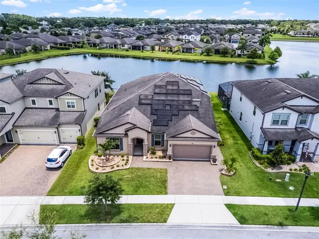 an aerial view of a house with outdoor space lake view