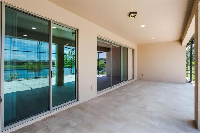 a view of a big house with a yard and lake view