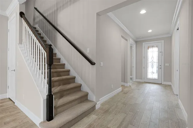 a view of a hallway with wooden floor and entryway