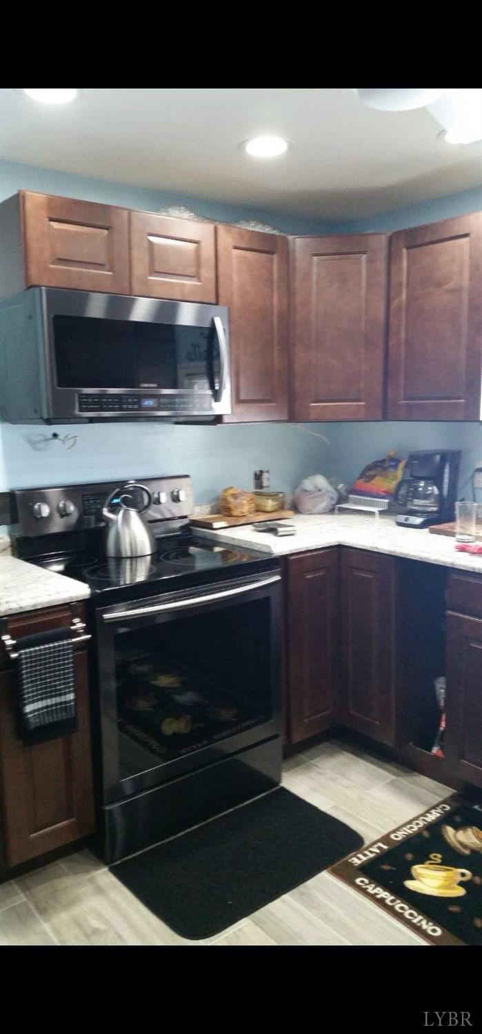 1999 High Peak Road Monroe, VA 24574 - Photo 6 of 15 a kitchen with granite countertop a stove and a sink