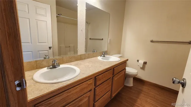 a bathroom with a double vanity sink and a mirror