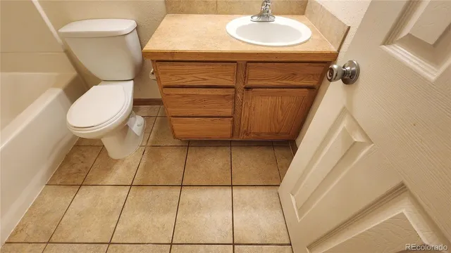 a bathroom with a sink toilet and mirror