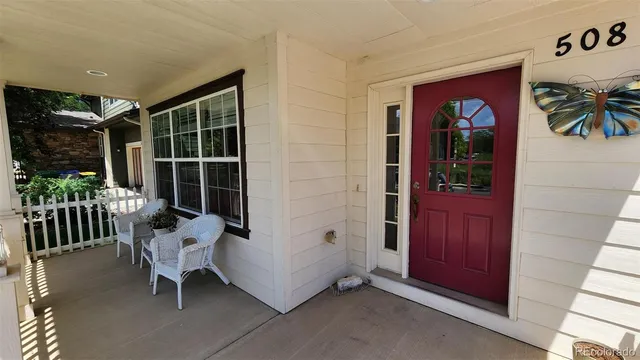 front view of a house with outdoor seating