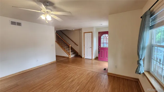 wooden floor in an empty room with a window