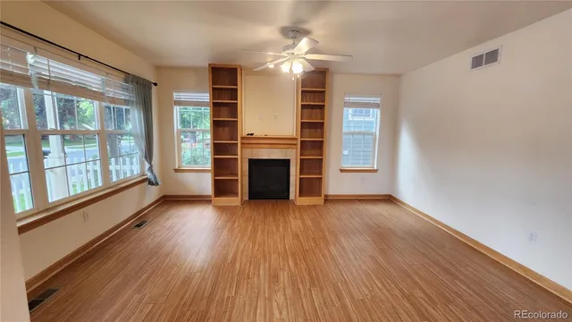 wooden floor in an empty room with a window