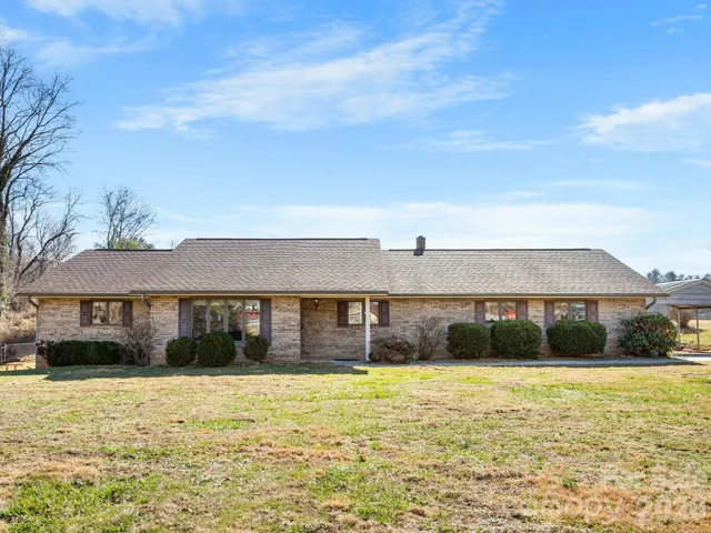 a view of a livingroom with wooden floor a ceiling fan and a window