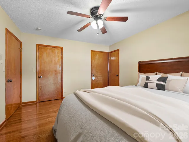 a bedroom with a bed and a ceiling fan