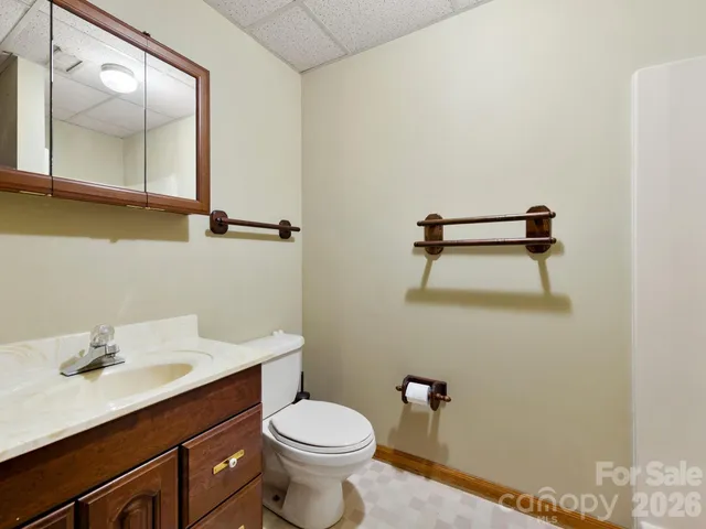 a bathroom with a sink a toilet and mirror