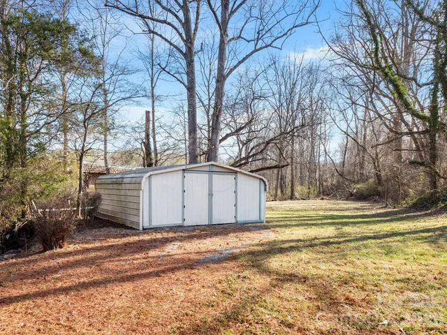 a view of a house with snow on the side of the road