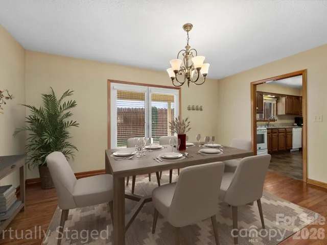 a view of a dining room with furniture wooden floor and chandelier