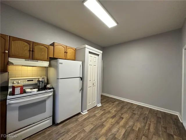 a white refrigerator freezer sitting inside of a kitchen