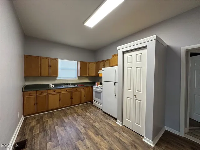 a kitchen with stainless steel appliances granite countertop a refrigerator and a stove top oven