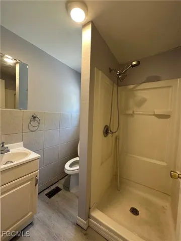 a bathroom with a shower a toilet and sink