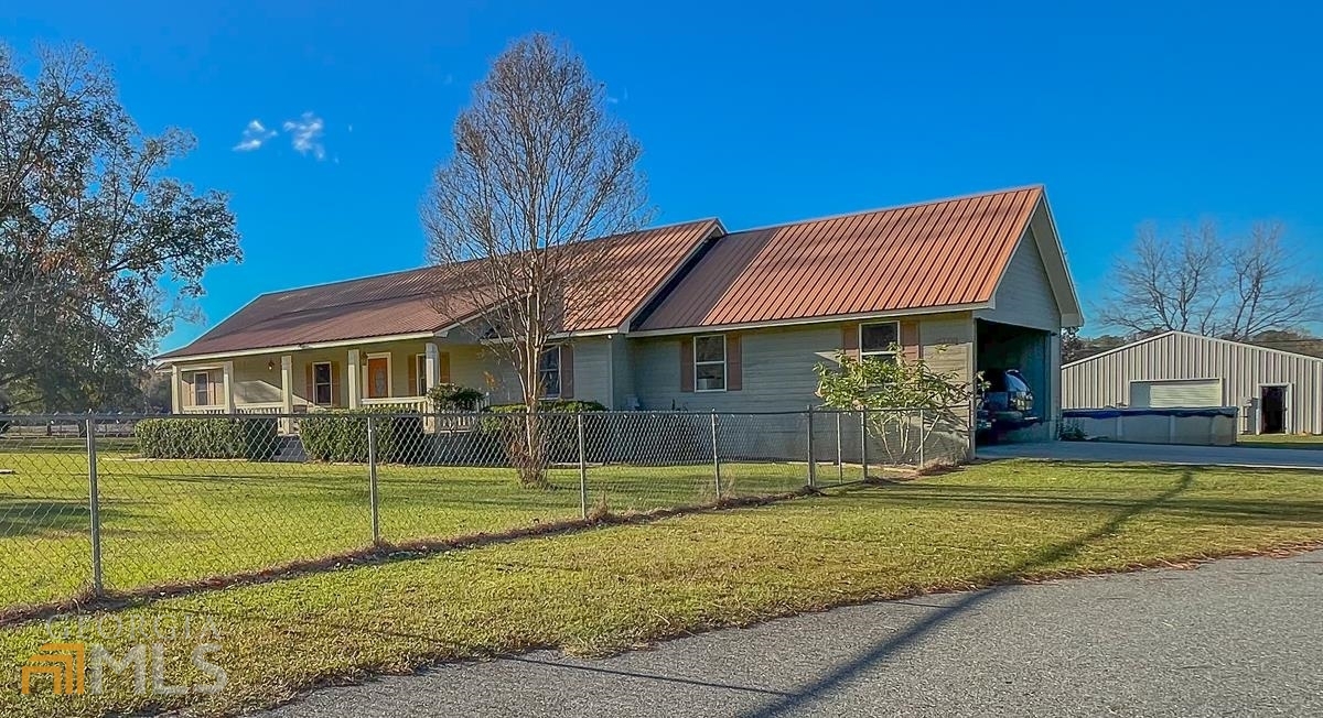 a front view of a house with swimming pool having outdoor seating