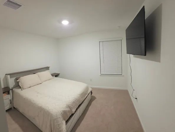 a living room with a bed and a window