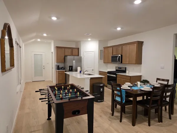 a kitchen with a dining table and chairs