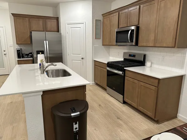 a kitchen with a sink a stove and refrigerator