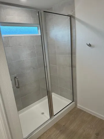 a bathroom with a glass shower door