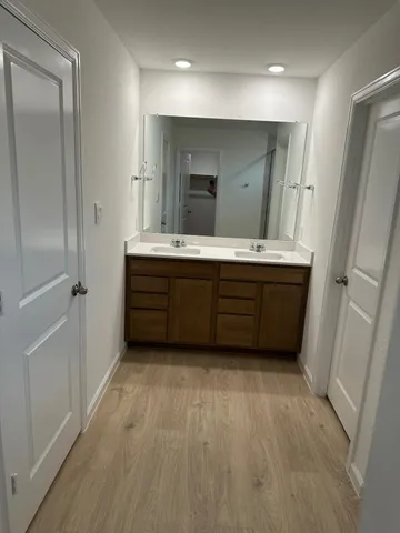 a bathroom with a tub sink and mirror