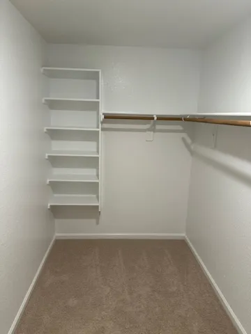 a view of an empty walk in closet