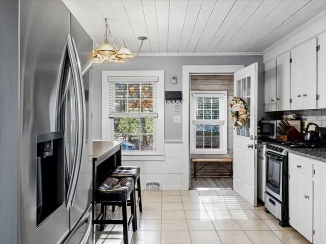 a kitchen with stainless steel appliances granite countertop a refrigerator and a stove top oven