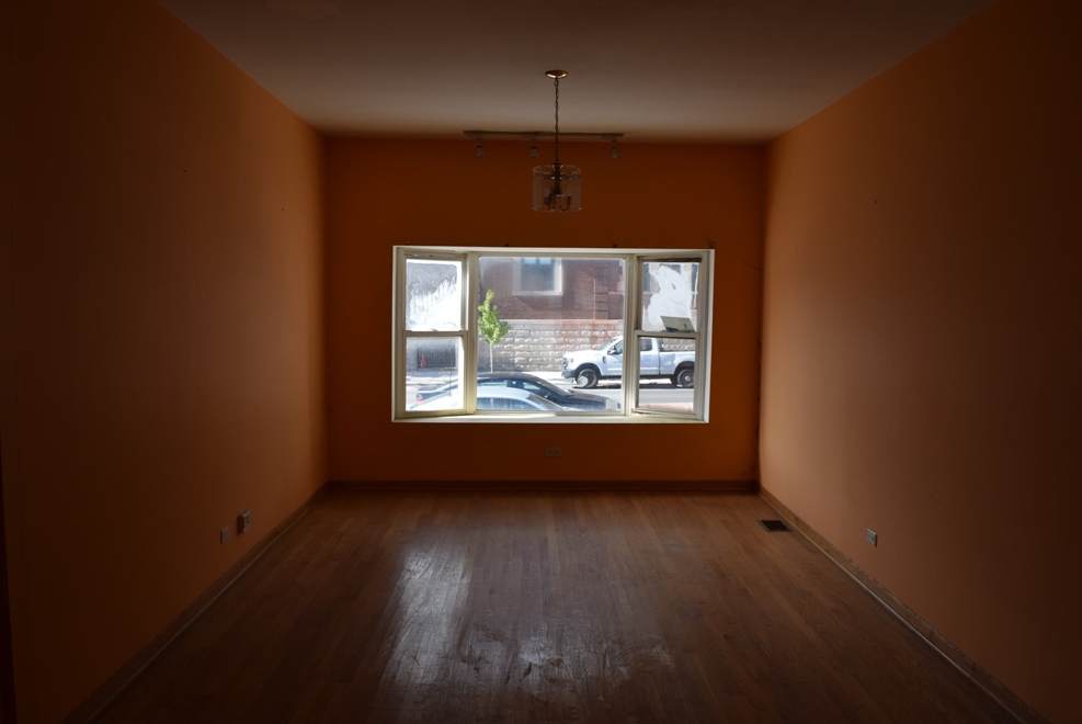 4519 North Western Avenue Chicago, IL 60625 - Photo 9 of 25 an empty room with wooden floor and windows