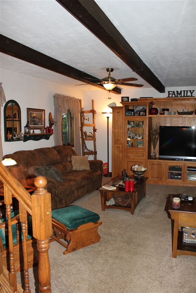 6056 North Knoll Road Monroe Center, IL 61052 - Photo 11 of 24 a living room with furniture and a flat screen tv