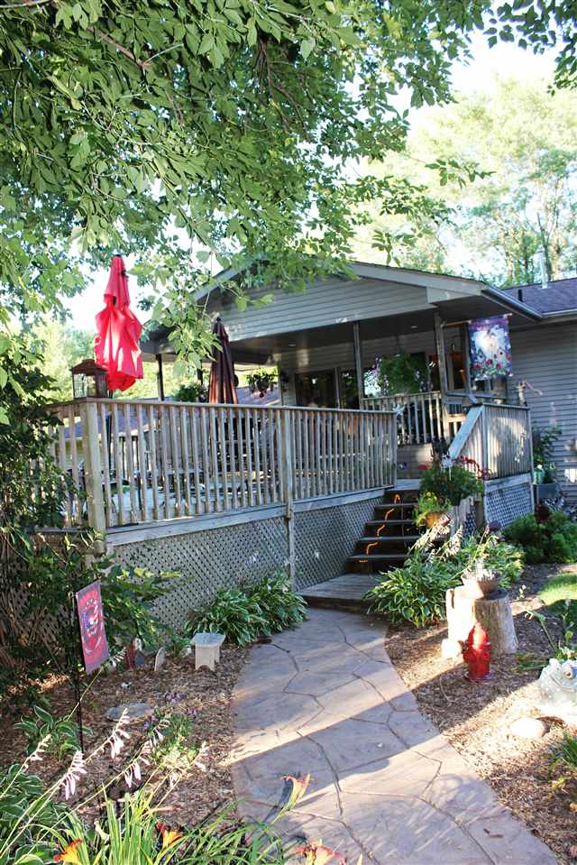 6056 North Knoll Road Monroe Center, IL 61052 - Photo 17 of 24 a view of a house with a small yard and wooden fence