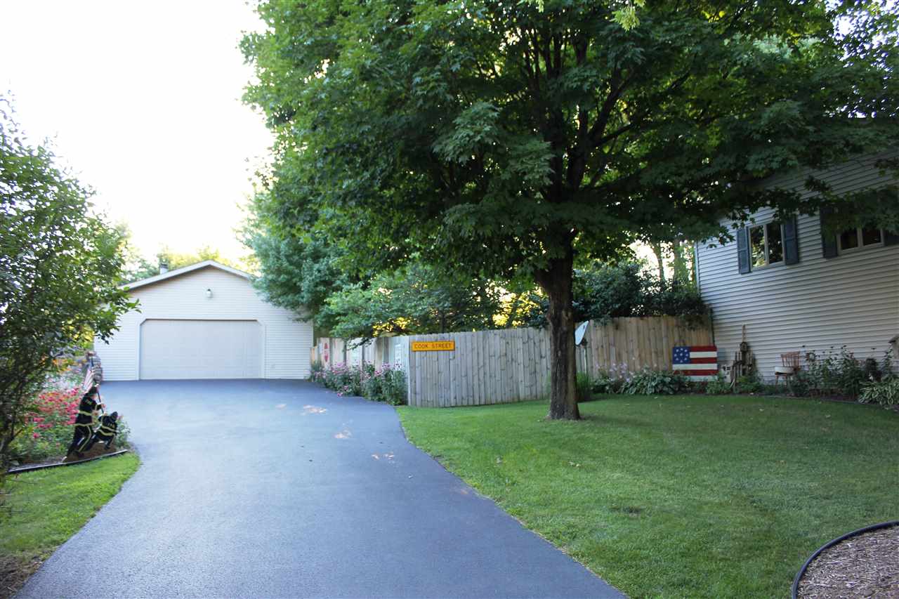 6056 North Knoll Road Monroe Center, IL 61052 - Photo 18 of 24 a view of a house with a yard and tree