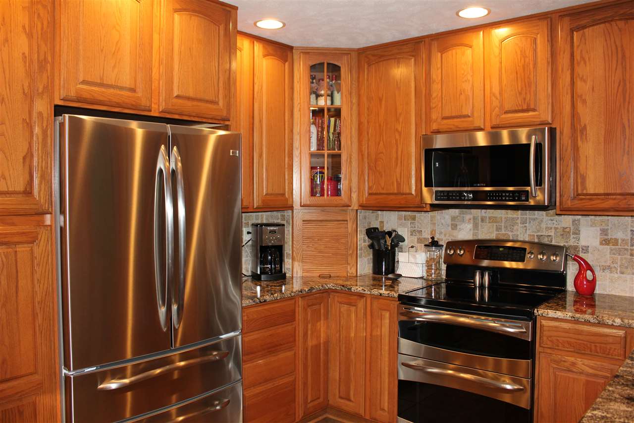 6056 North Knoll Road Monroe Center, IL 61052 - Photo 3 of 24 a kitchen with stainless steel appliances a refrigerator stove and microwave