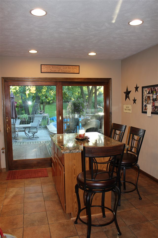 6056 North Knoll Road Monroe Center, IL 61052 - Photo 4 of 24 a dining room with a wooden table and chairs