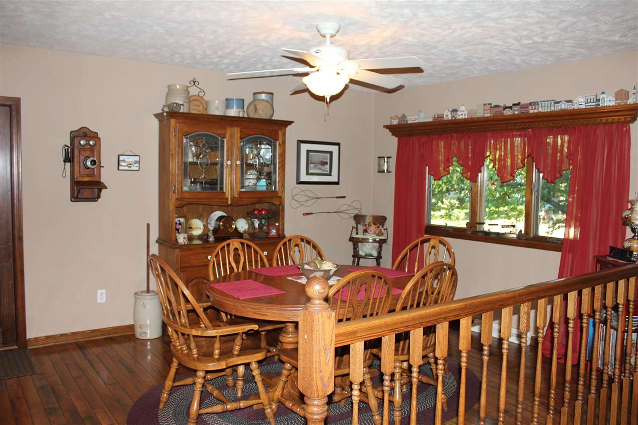6056 North Knoll Road Monroe Center, IL 61052 - Photo 5 of 24 a view of a dining room with furniture window and wooden floor