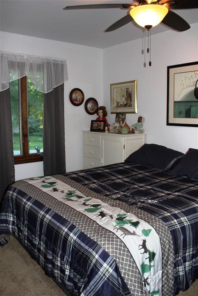 6056 North Knoll Road Monroe Center, IL 61052 - Photo 7 of 24 a bedroom with a bed and a chandelier