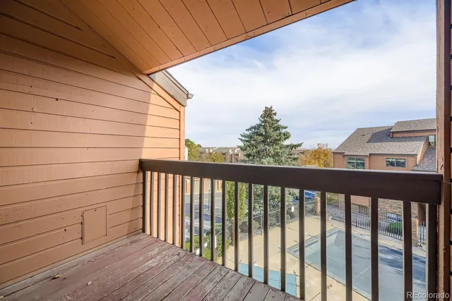 a view of a balcony with wooden fence and floor