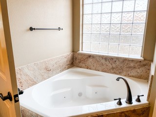 1306 Keenland Road Corpus Christi, TX 78418 - Photo 26 of 26 a bath tub sitting in a bathroom next to a window