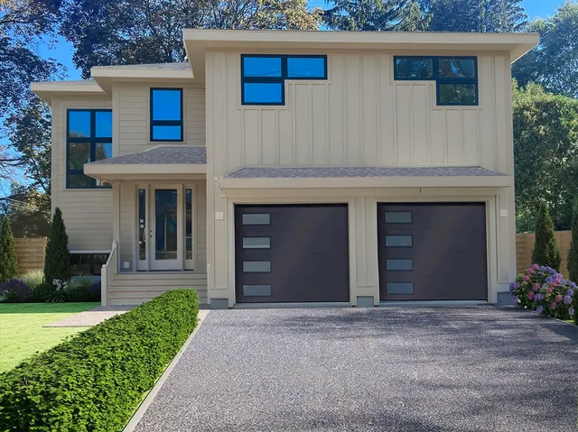 a view of a house with a yard and a garage