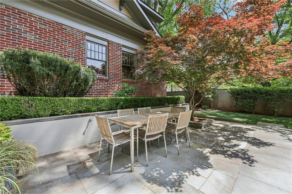 429 Adams Street Decatur, GA 30030 - Photo 40 of 100 a patio with table and chairs and potted plants