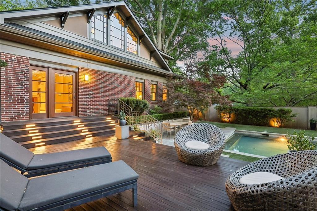 429 Adams Street Decatur, GA 30030 - Photo 79 of 100 a view of a patio with couches table and chairs with wooden floor and fence