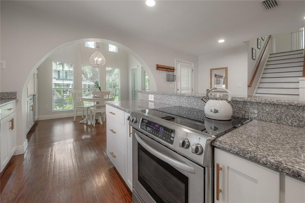 3108 West Villa Rosa Street Tampa, FL 33611 - Photo 15 of 58 a view of a kitchen with a stove wooden floor and a large window