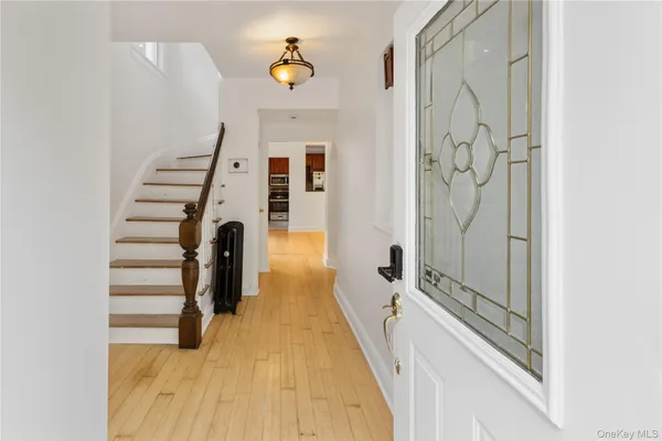 a view of a hallway with wooden floor and staircase